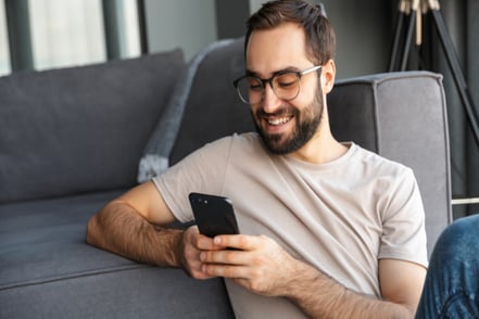 man working remote looking at phone